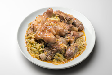 White plate with pork meat and savoy cabbage