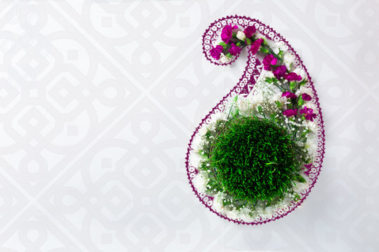 Novruz concept samani or semeni or sabzi for spring equinox March celebration in buta shape, paisley pattern motive, oriental style, nowruz or navruz background, copy space for text
