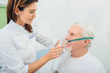 Senior man preparing to procedure inhalation at hospital