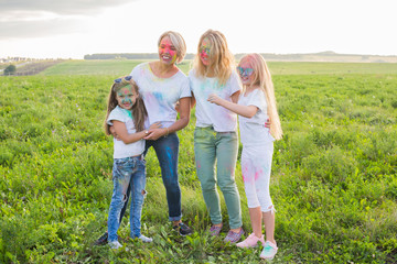 Holiday, summer and fun concept - Group of people dancing in field at holi festival