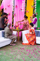 Indian family celebrating Ganesh festival with Ganesha Idol