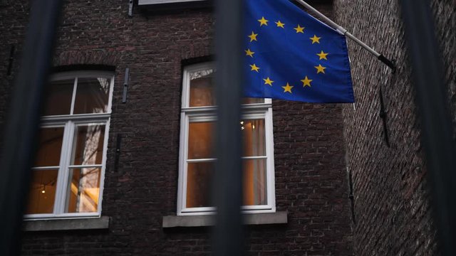 EU Flag behind bars, Brexit symbol, metaphor for remainers, Brexiteers, 4k footage