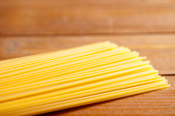  Spaghetti on brown wooden table. Background. National traditional italian healthy food. Ingredient. Background. Close-up.