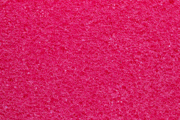 Sponge texture background. Close-up of red bath sponge texture with porous structure for background. Macro.