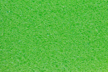 Sponge texture background. Close-up of green bath sponge texture with porous structure for...