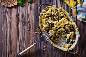 Delicious and healthy brussels sprouts baked in cream sauce with cheese and bread crumbs on a...