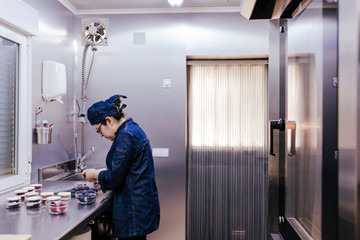 woman working on bakery preparing sweets