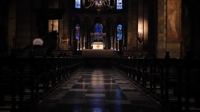 Old person sits in the pews of a beautiful old church with a gorgeous marbled floor,  Basilica of Our Lady, Maastricht, The Netherlands,, 4k footage