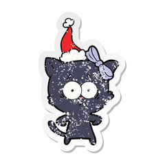 distressed sticker cartoon of a cat wearing santa hat