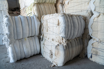 Interior of a storehouse .Stacked waste textile scraps In Bales.