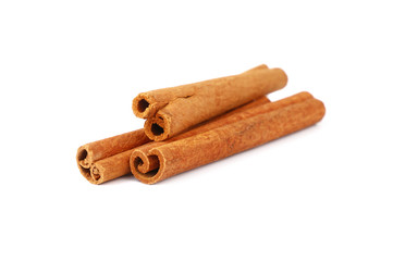 Close up three cinnamon sticks isolated on white