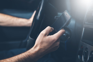 .young man hand phone in car