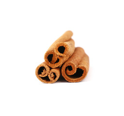 Close up three cinnamon sticks isolated on white