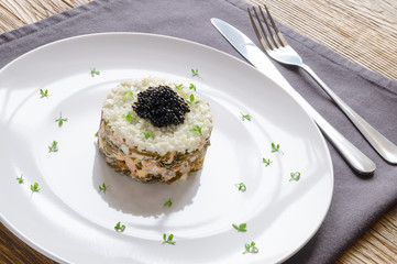 humpback salmon, seaweed, egg nad onion tower salad derssed with mayonnaise, toped with halibut caviar, and decorated with garden cress