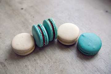 blue and white cakes maccarone lie on a gray