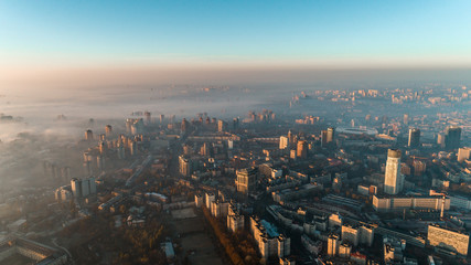 Naklejka na ściany i meble Aerial view of the city in dense fog