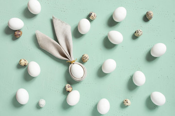 Pattern of chicken and quail eggs with bunny ears of linen napkin