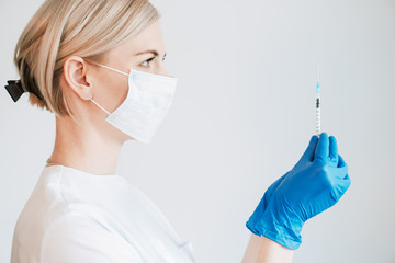 A woman holding a syringe or a vaccine. Preparation for injection.