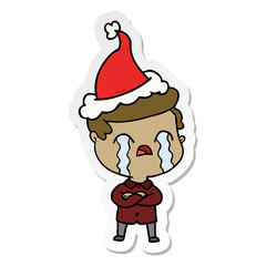 sticker cartoon of a man crying wearing santa hat