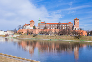 Wawel Royal Castle famous landmark in Krakow Poland. Picturesque landscape on coast river Vistula.  Blue sky and cloud. February 23, 2019.