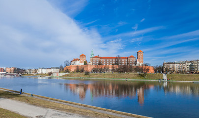 Fototapeta na wymiar The Wawel Castle on blue sky background. Castle residency located in central Krakow, Poland. February 23, 2019.