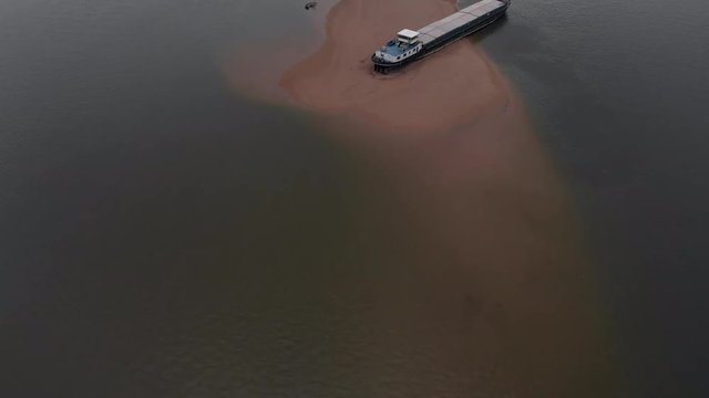 Aerial Reveal: Cargo Barge Stuck on Danube River Sandbank.