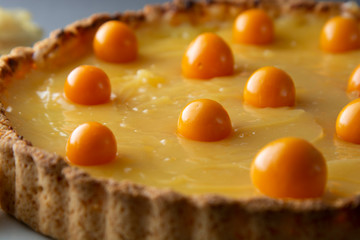 Lemon curd pie. Homemade delicious pie ,tart filled with lemon curd. Sweet dessert. Lemon curd pie decorated with physalis.