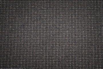 Fototapeta na wymiar Black fabric texture background. Dark woven clothing material.