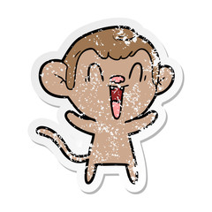 distressed sticker of a cartoon laughing monkey