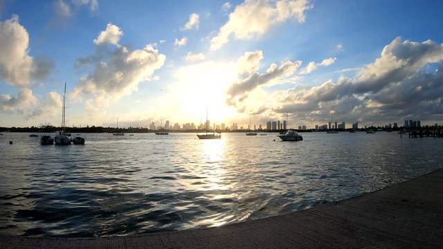 Boats by Miami Beach bay walk at sunset. Florida, USA