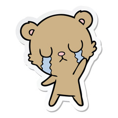sticker of a crying cartoon bear waving