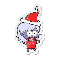 distressed sticker cartoon of a shocked elf girl wearing santa hat