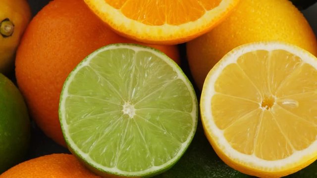 Sliced juicy orange, lime and limon on citrus fruit background, medicine and food concept. Rotate