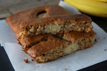 Banana bread with oat flour. Top view of homemade banana bread on wooden background. Ideas and recipes for healthy diet breakfast.