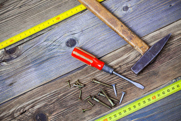 Vintage hammer, screwdriver, screws and measuring tape