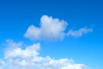 Naklejka na ściany i meble Blue sky and fluffy cumulus white clouds North Sea island.