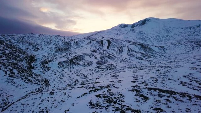 hd drone pull back shot over mystic and deserted snowy mountain view, in Turkey