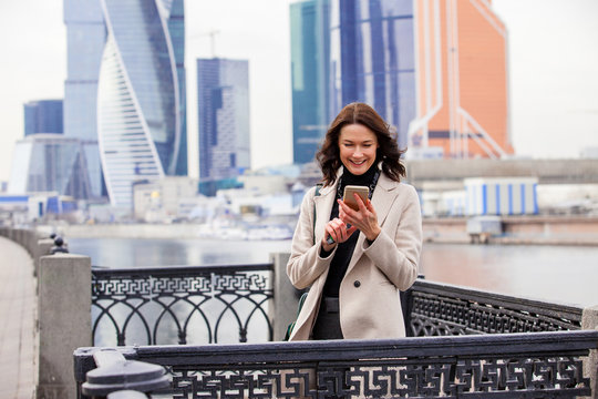 smiling beautiful middle-aged woman with a smartphone
