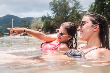 Best friends in bikini enjoying the water on summer vacation