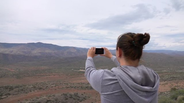 Woman taking picture of desert in Arizona in slow motion 250fps