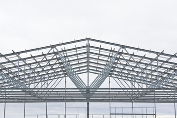 Structure of steel for building construction on sky background at the construction site