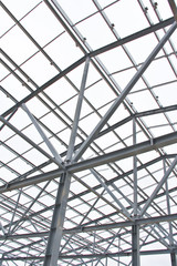 Structure of building from galvanized metal. Steel construction on sky background. Metal galvanizing technology to prevent corrosion.