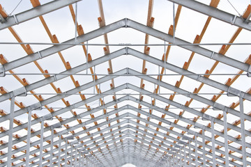 Metal frame new cowshed on the farm. The construction phase of the building. Construction of a metal frame for further insulation.