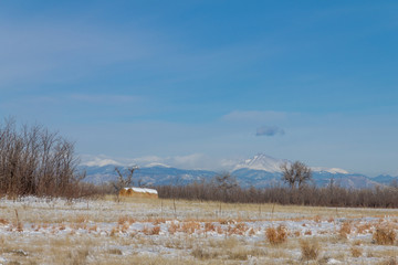 Field and hay bale with Longs Peak in the background, from Rocky Mountain Arsenal, Colorado.