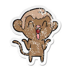 distressed sticker of a cartoon laughing monkey
