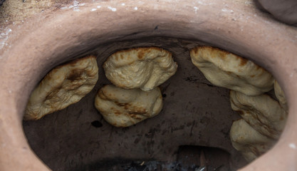 Making bread in tandoor oven