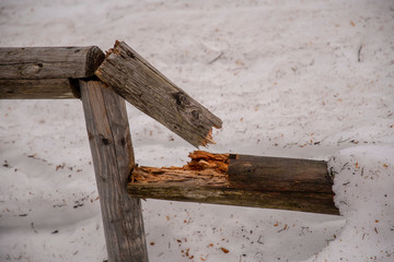 broken wooden fence in winter at a cattle pasture