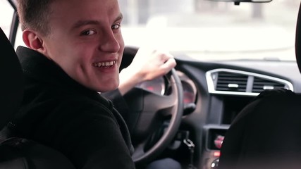 happy driver in car salon smiling and showing thumb up