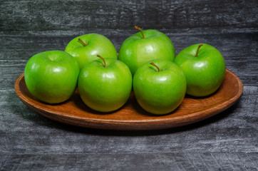 green apples on wooden table
