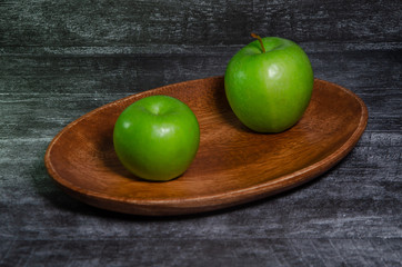 green apples on wooden table